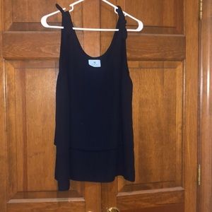 Dark blue tank tops with a bow at each sleeve top. Layered front